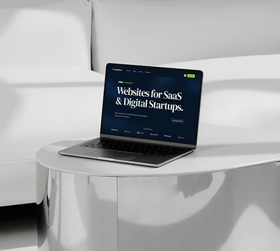 Website displayed on a laptop in a minimal interior