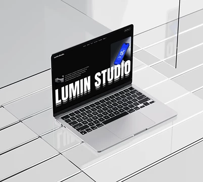 Dark studio website displayed in a white architectural setting